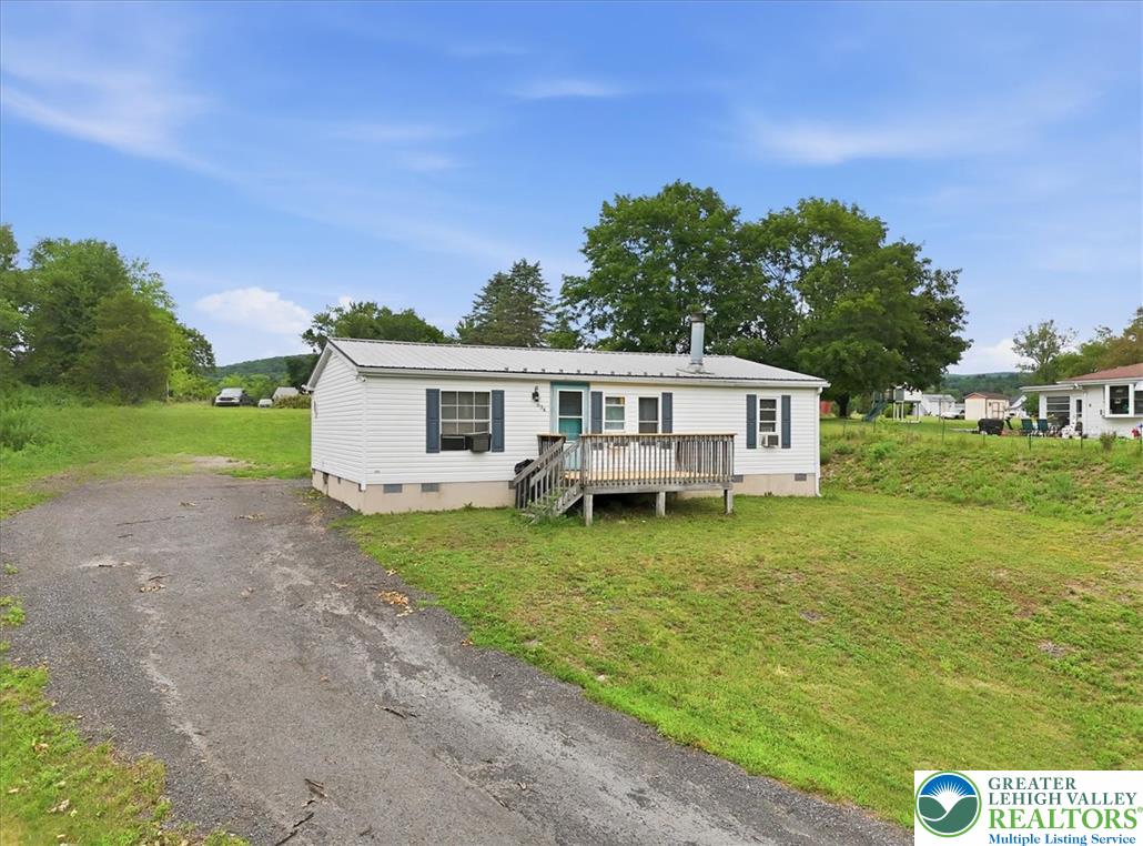 634 Main Road Lehighton, PA 18235 - Photo 39 of 39 A well-maintained single-story residence with a metal roof and inviting front deck.