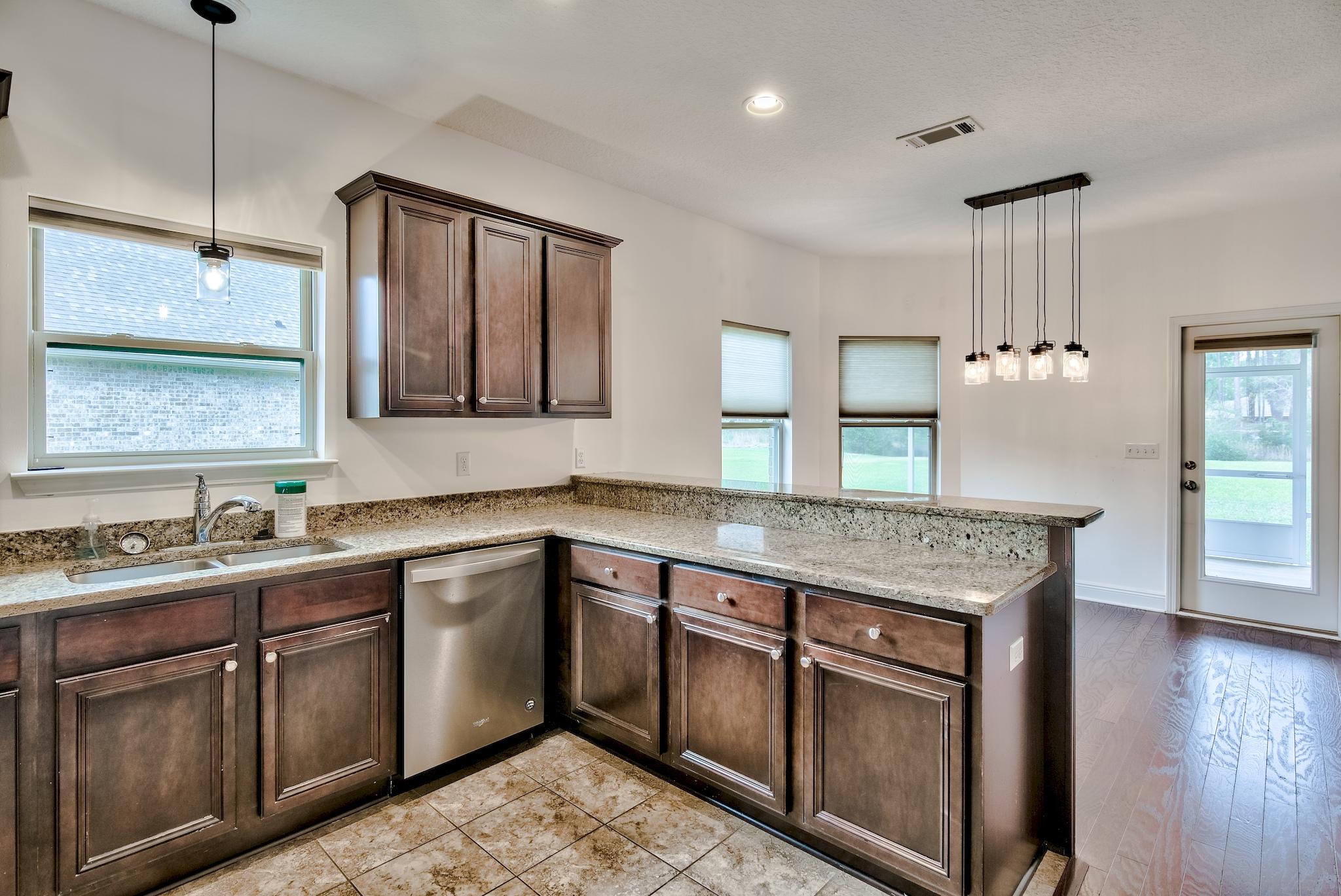 70 Riverbirch Loop Santa Rosa Beach, FL 32459 - Photo 11 of 45 a kitchen with a sink stove and wooden floor