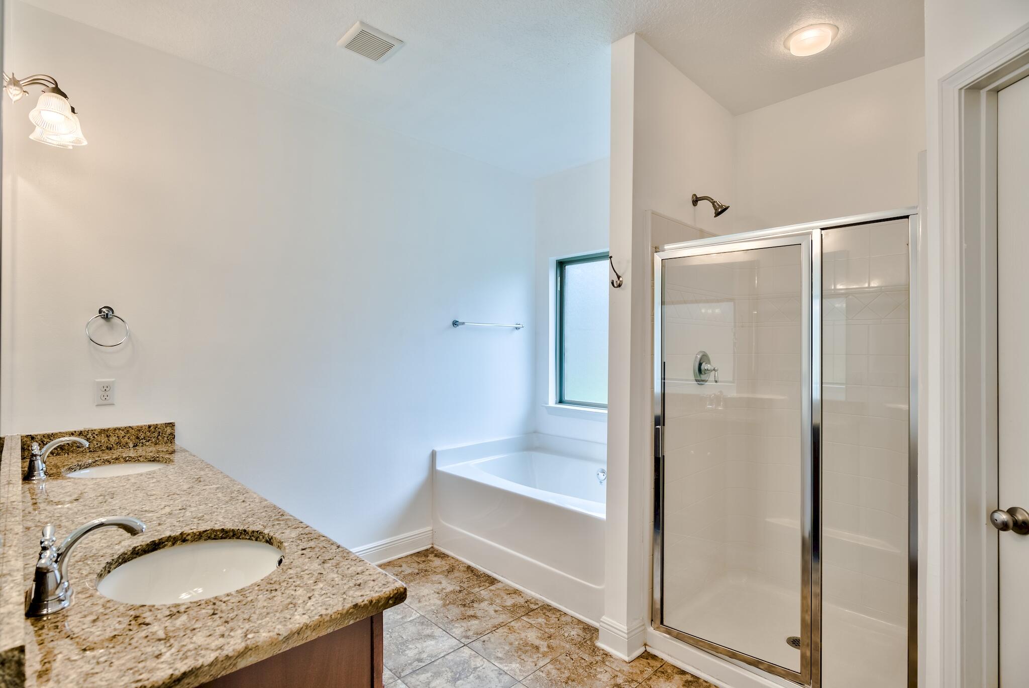 70 Riverbirch Loop Santa Rosa Beach, FL 32459 - Photo 15 of 45 a bathroom with a granite countertop tub shower and mirror