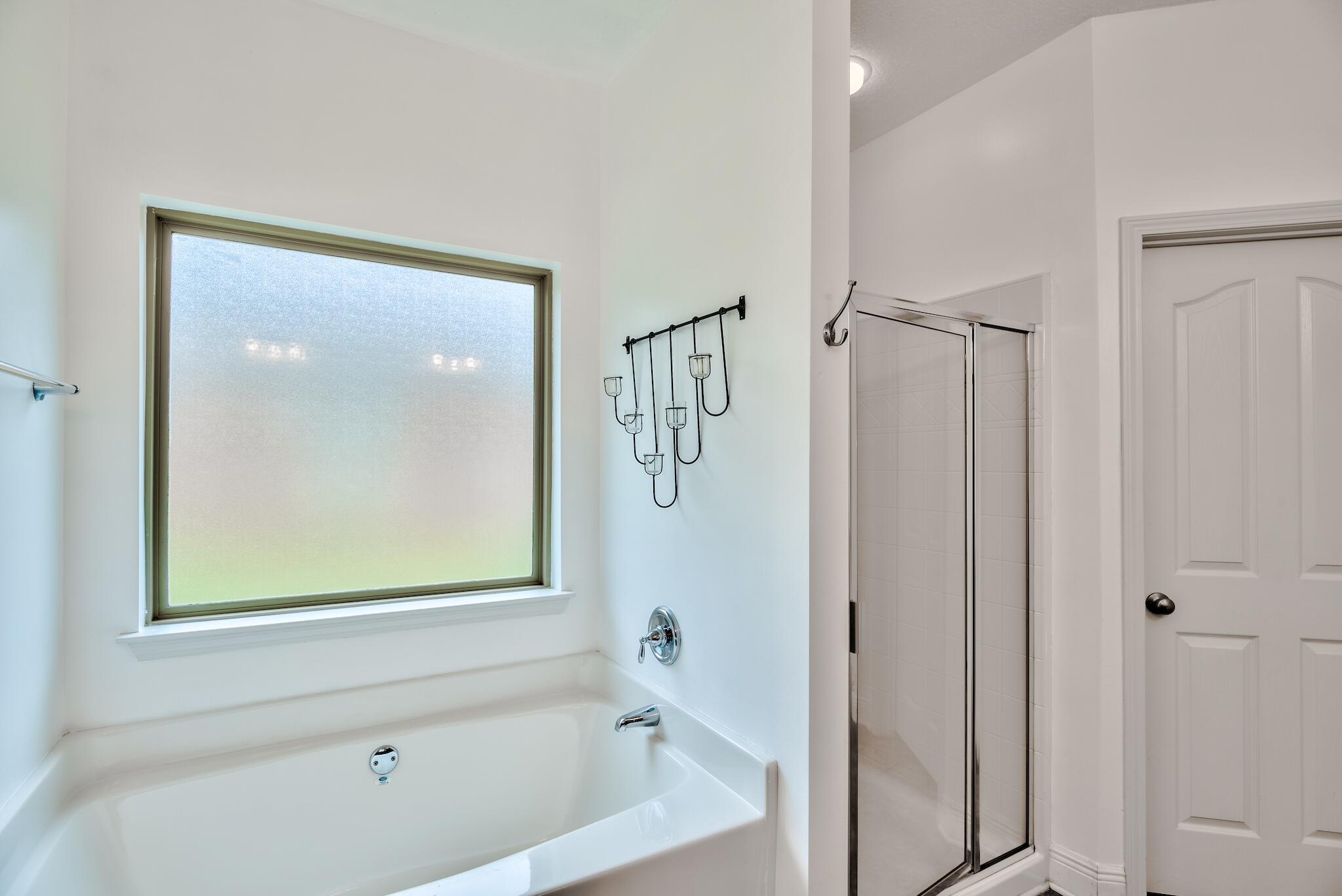 70 Riverbirch Loop Santa Rosa Beach, FL 32459 - Photo 16 of 45 a bathroom with a bathtub shower and a sink