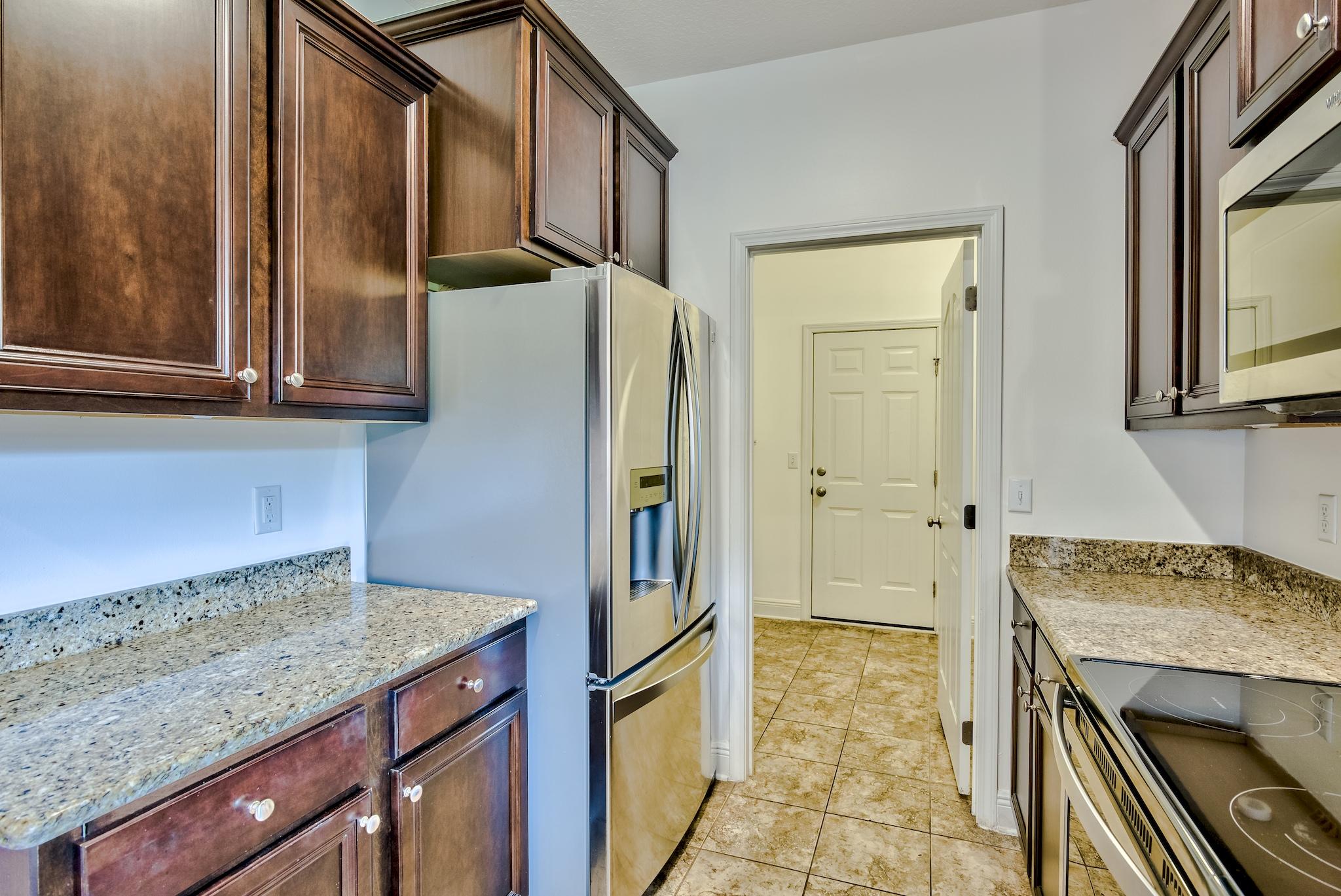 70 Riverbirch Loop Santa Rosa Beach, FL 32459 - Photo 9 of 45 a kitchen with stainless steel appliances granite countertop a refrigerator and a stove