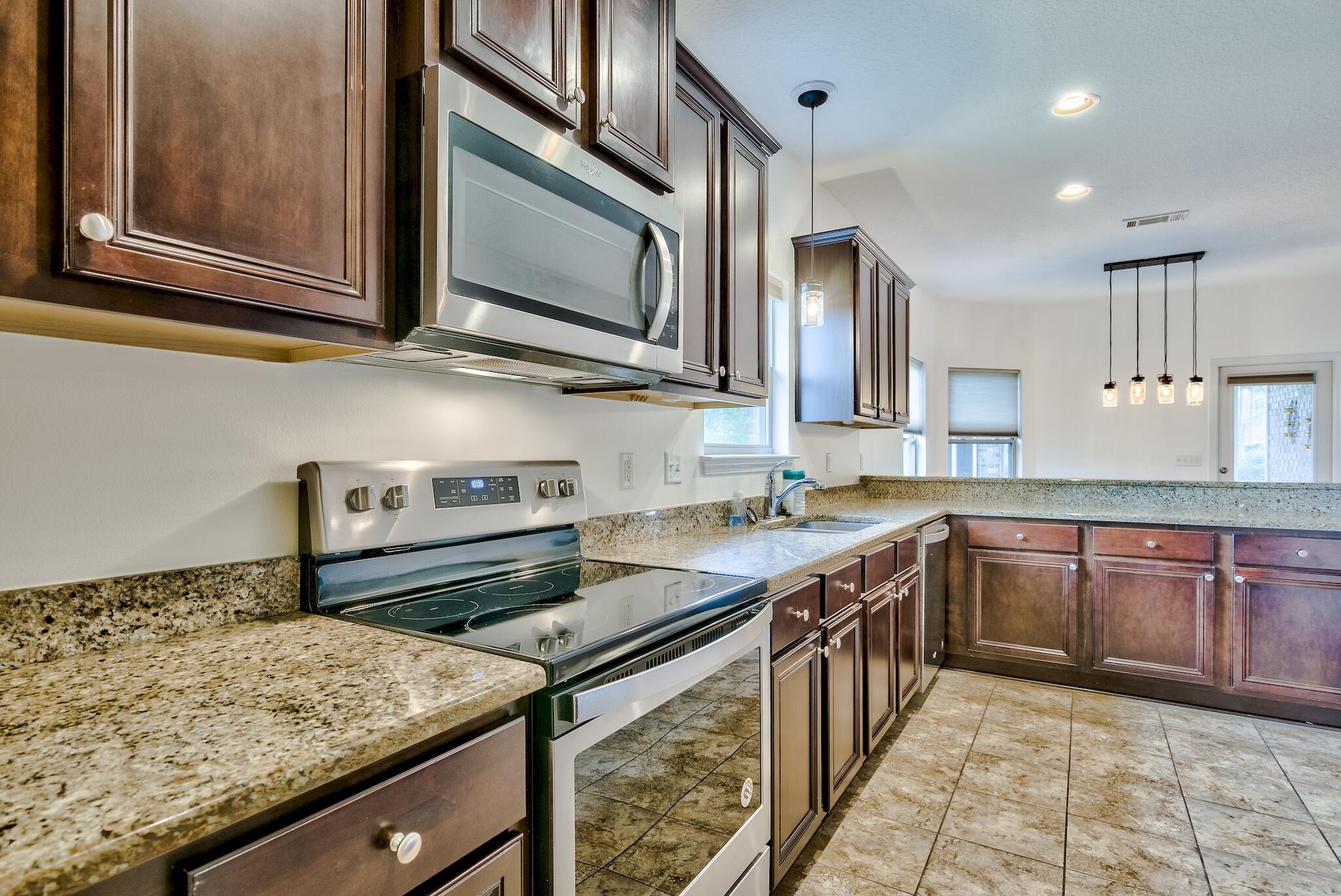 70 Riverbirch Loop Santa Rosa Beach, FL 32459 - Photo 10 of 45 a kitchen with stainless steel appliances granite countertop a sink stove and microwave
