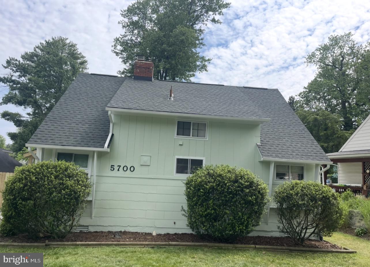 5700 Stillwell Road Rockville, MD 20851 - Photo 2 of 19 a front view of a house with a garden