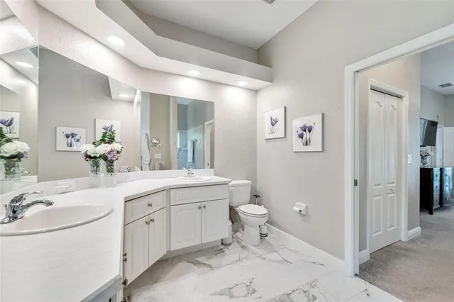 a dining room with furniture water view and a floor to ceiling window