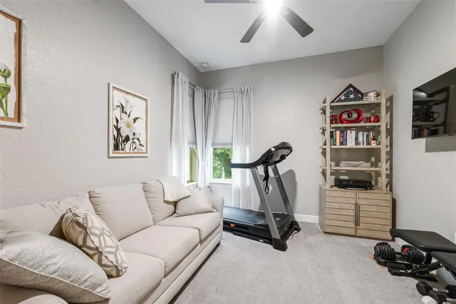 a view of a house with backyard and sitting area
