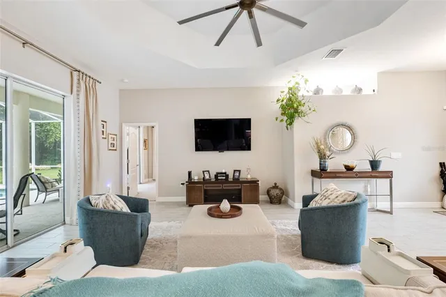 a living room with furniture and a chandelier