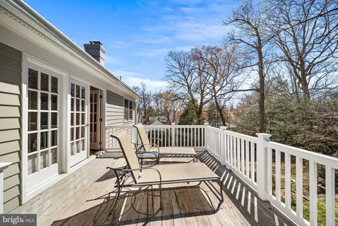 a bathroom with a granite countertop sink and a window