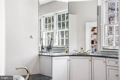 a living room with a book shelf and a book shelf