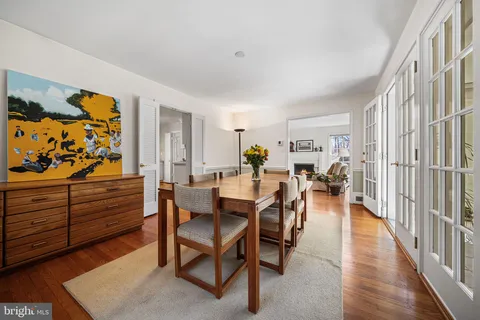 a dining room with furniture and wooden floor
