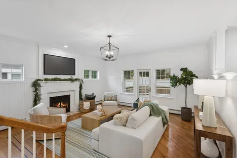 a living room with furniture a fireplace and a flat screen tv