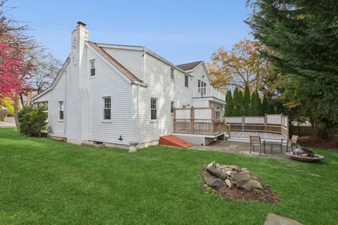 a view of a house with a yard and sitting area