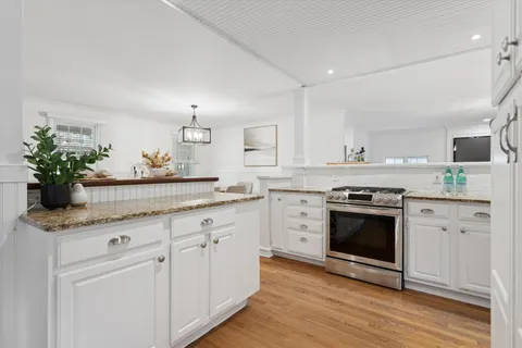 a kitchen with stainless steel appliances white cabinets a sink and dishwasher