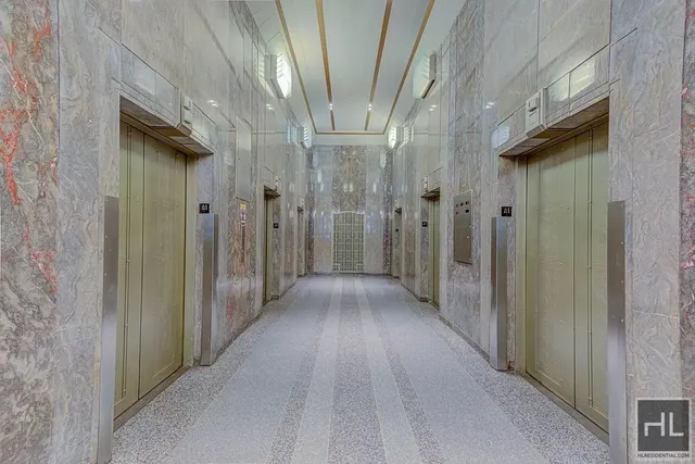 a living room with fireplace furniture and a large window