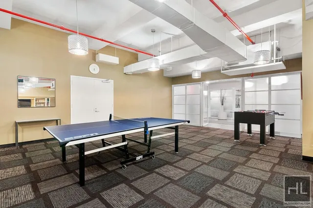 a room with gym equipment and large window