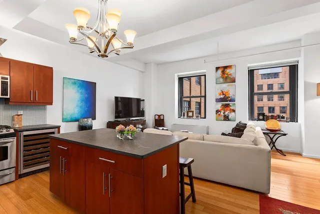 a work place with granite countertop furniture and a flat screen tv