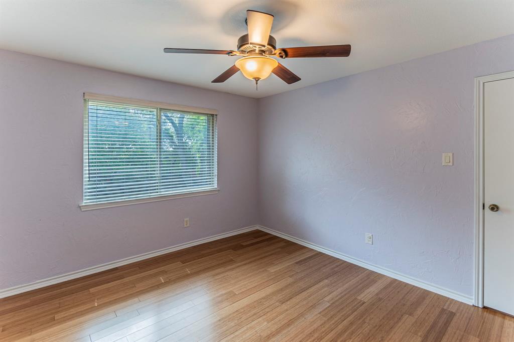 127 Nicklaus Nook Lancaster, TX 75146 - Photo 27 of 37 Empty room featuring light wood-style flooring, a ceiling fan, and a textured wall