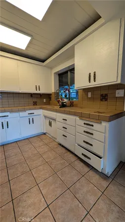 a kitchen with granite countertop a sink and a stove