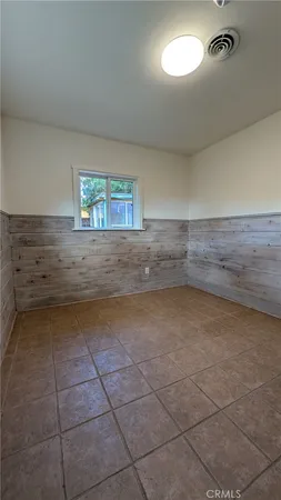 a view of garage with wooden fence