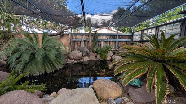 a view of a patio with table and chairs under an umbrella
