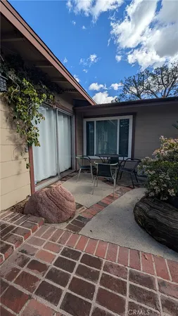 a backyard of a house with table and chairs