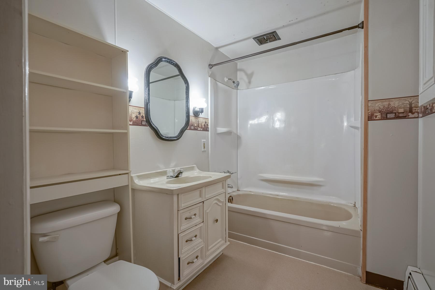 32 Tilbury Road Salem, NJ 08079 - Photo 15 of 30 a bathroom with a toilet sink vanity tub and shower