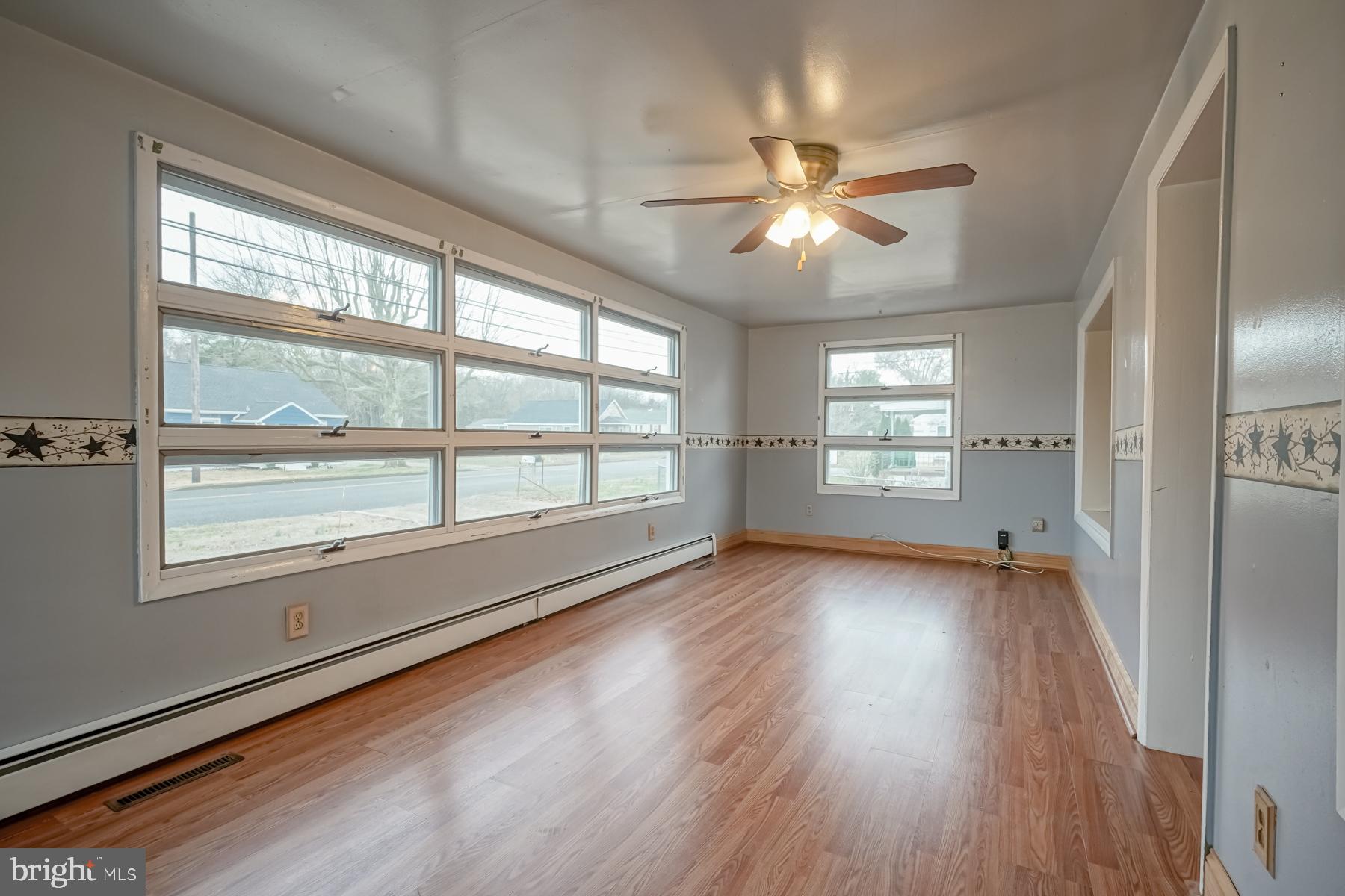 32 Tilbury Road Salem, NJ 08079 - Photo 2 of 30 a view of an empty room with wooden floor and a window
