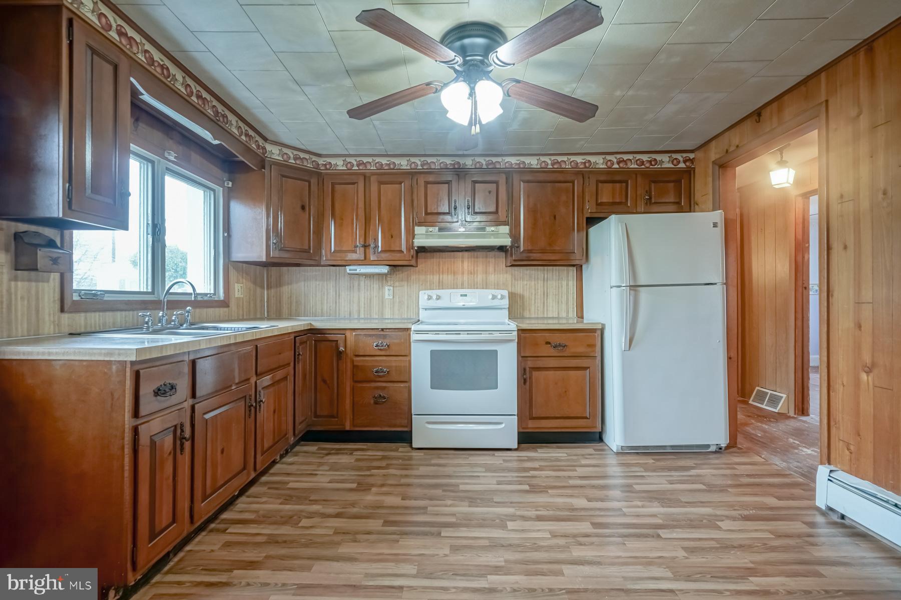 32 Tilbury Road Salem, NJ 08079 - Photo 7 of 30 a kitchen with a refrigerator sink and cabinets