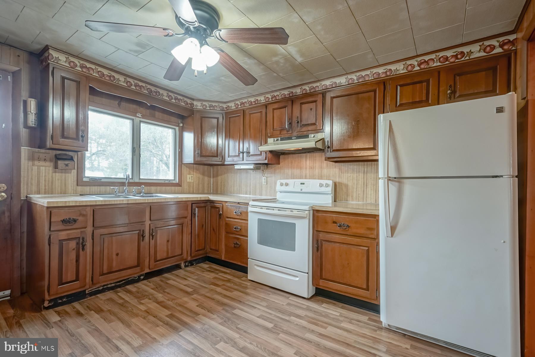 32 Tilbury Road Salem, NJ 08079 - Photo 8 of 30 a kitchen with stainless steel appliances granite countertop a refrigerator a sink dishwasher a stove and white countertops with wooden floor