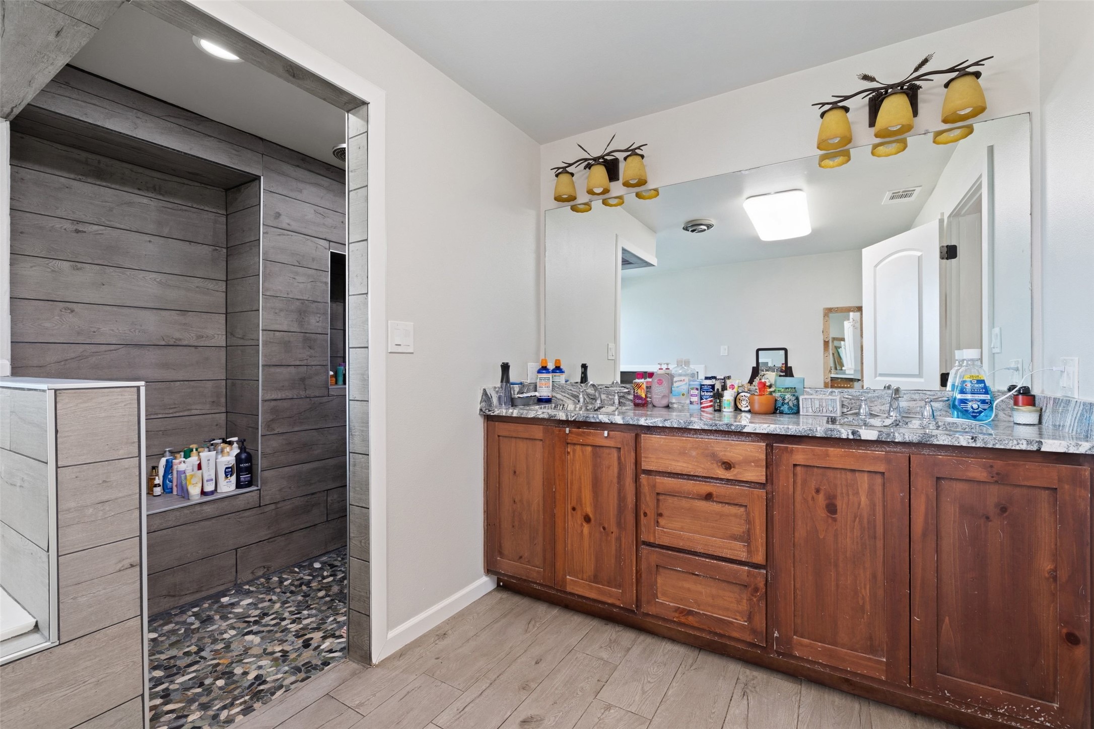1301 County Road 228 Florence, TX 76527 - Photo 19 of 40 a bathroom with a sink and a mirror
