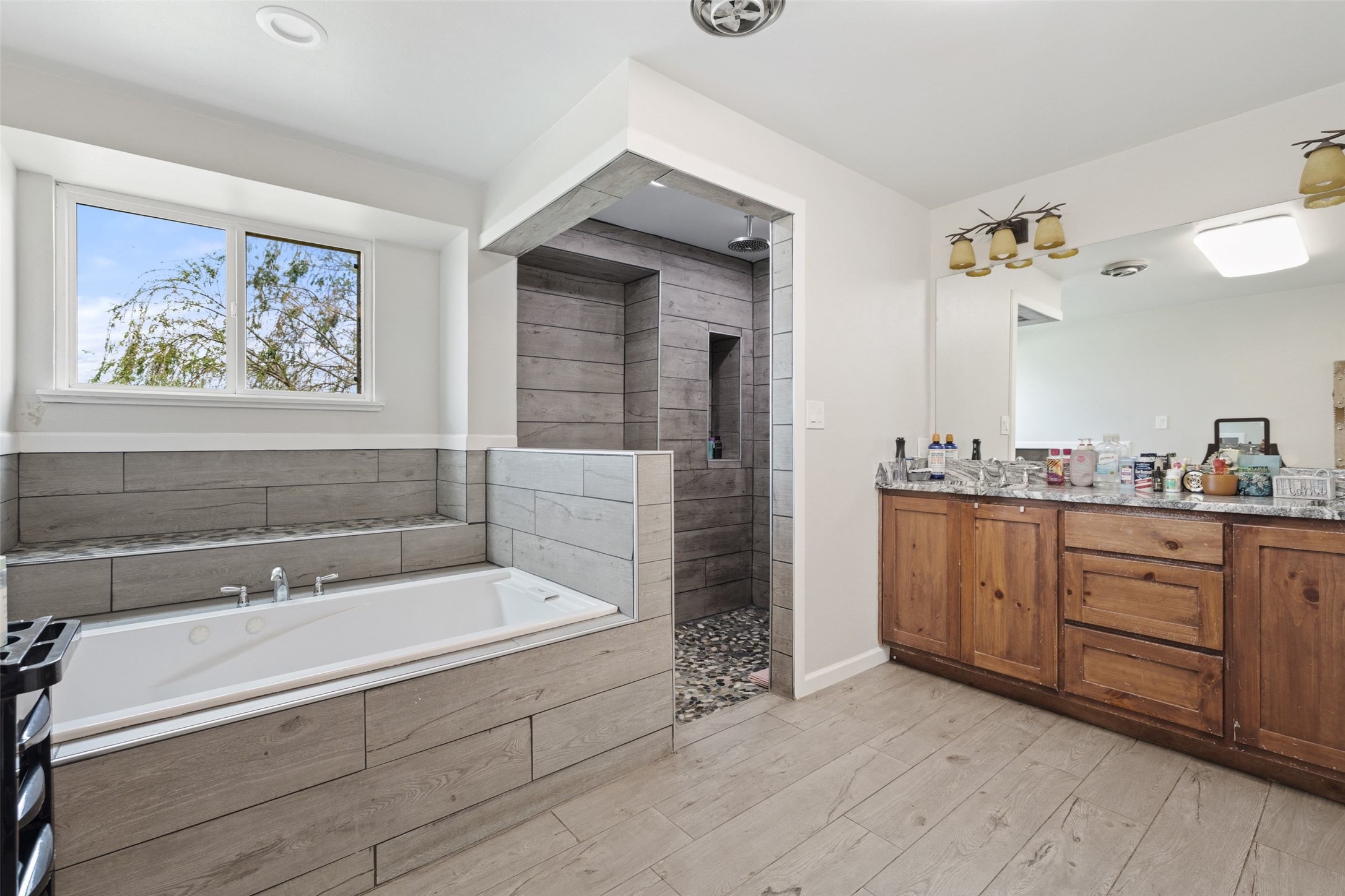 1301 County Road 228 Florence, TX 76527 - Photo 20 of 40 a spacious bathroom with a tub sink and mirror