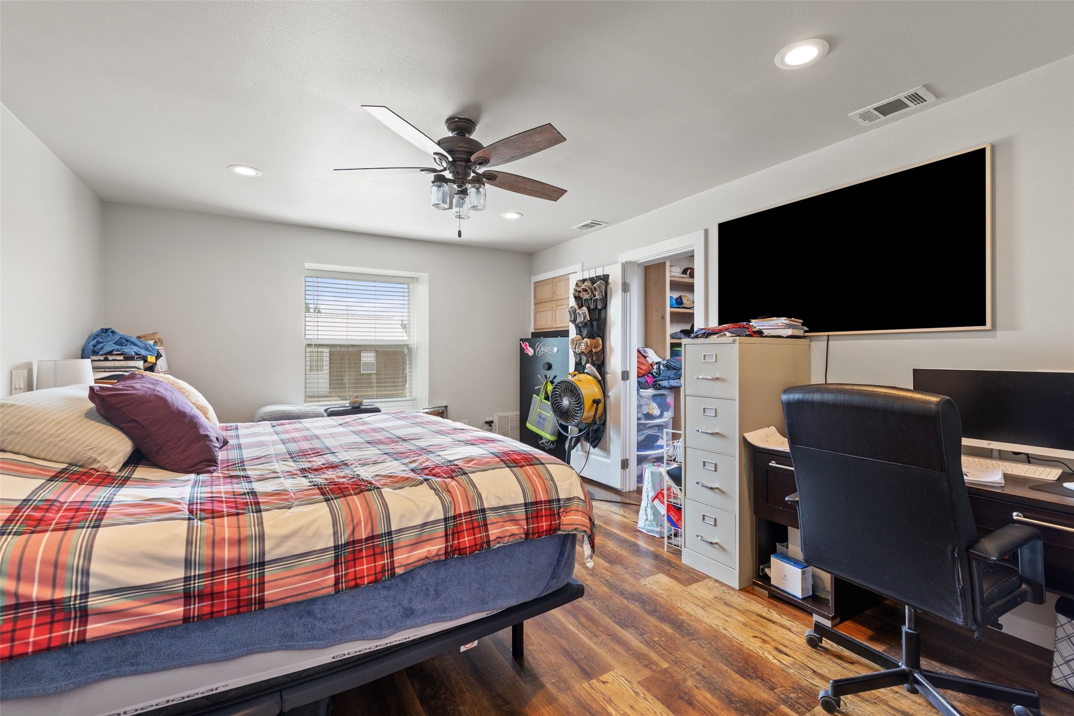 1301 County Road 228 Florence, TX 76527 - Photo 23 of 40 a bedroom with a bed and a flat screen tv