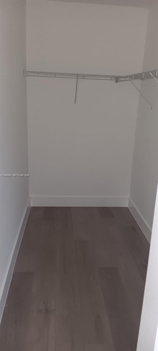 143 Southwest 9th Street, Unit 301 Miami, FL 33130 - Photo 9 of 16 a view of a room with racks on the wall