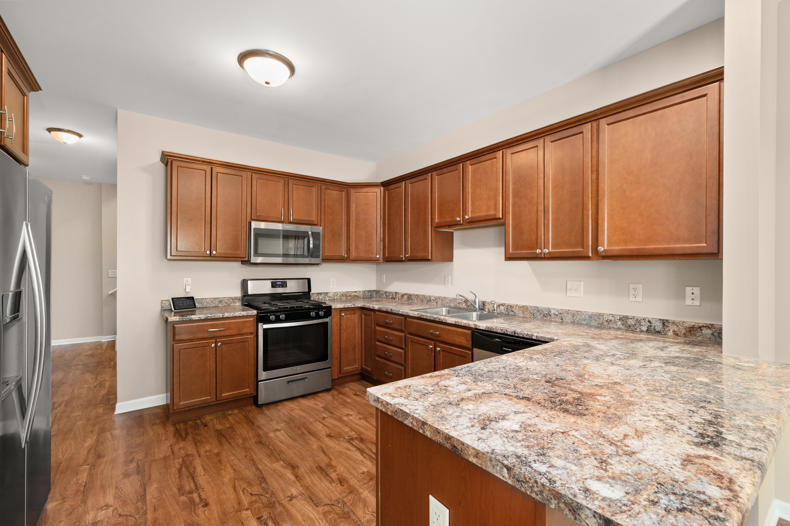 3705 Green Tree Lane DeKalb, IL 60115 - Photo 9 of 31 a kitchen with granite countertop wooden cabinets and a stove top oven
