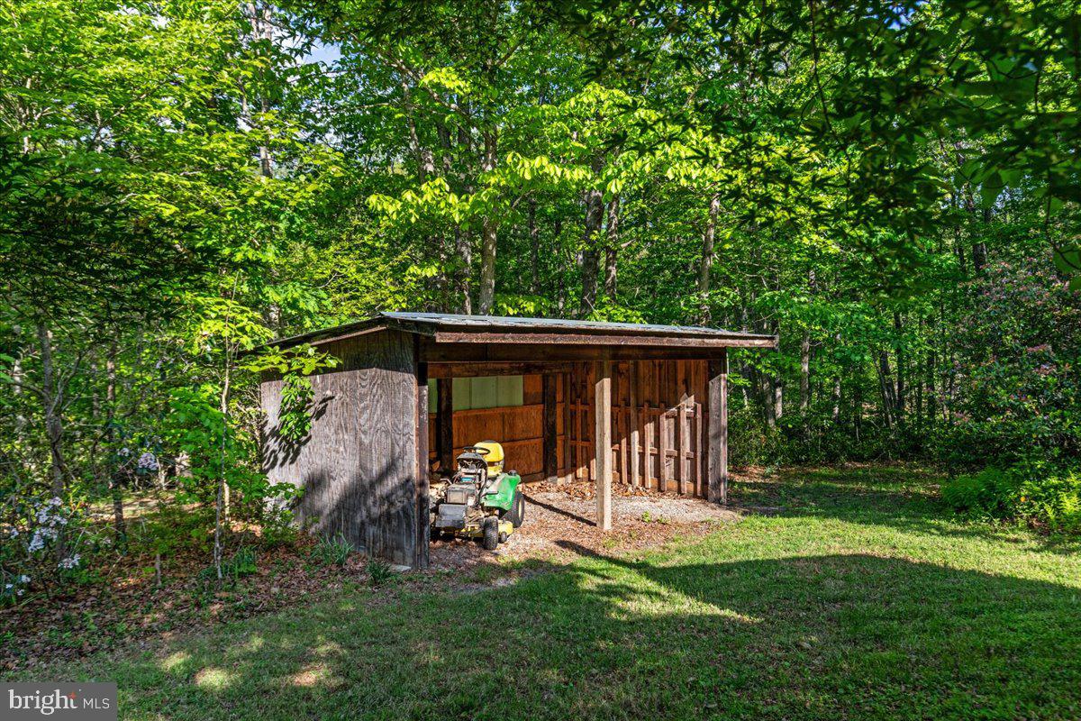 146 Lizzie Mills Road Castleton, VA 22716 - Photo 54 of 91 a view of a wooden house with a yard
