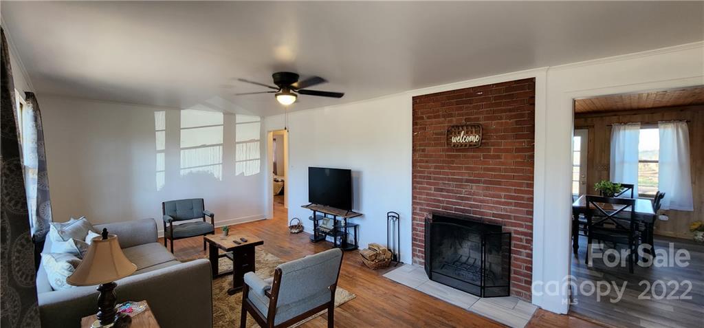 157 Moss Road Rutherfordton, NC 28139 - Photo 3 of 36 a living room with furniture a fireplace and a flat screen tv