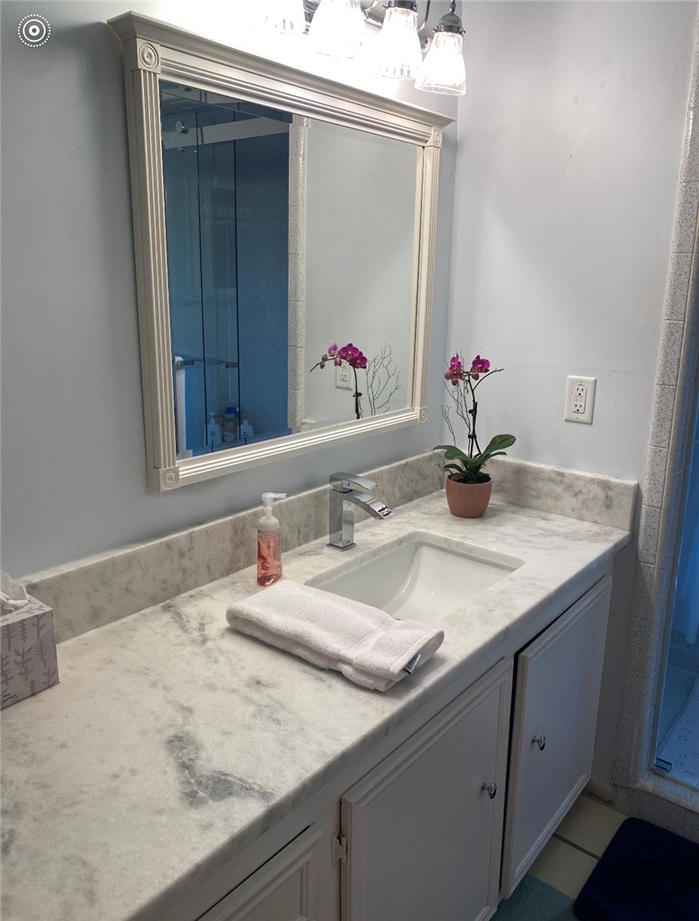 2902 Chaparral Circle Bryan, TX 77802 - Photo 14 of 26 a bathroom with a granite countertop sink and a mirror