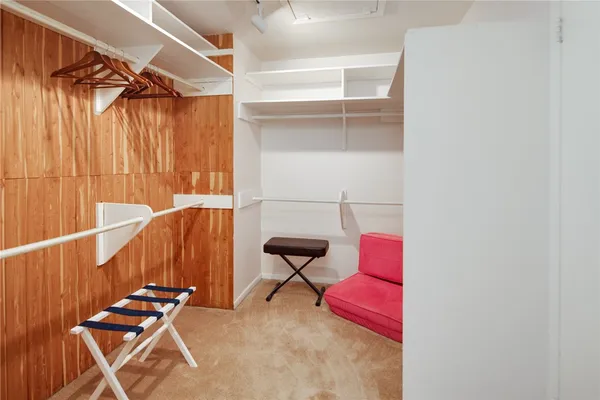 a view of hallway with chairs and wooden floor