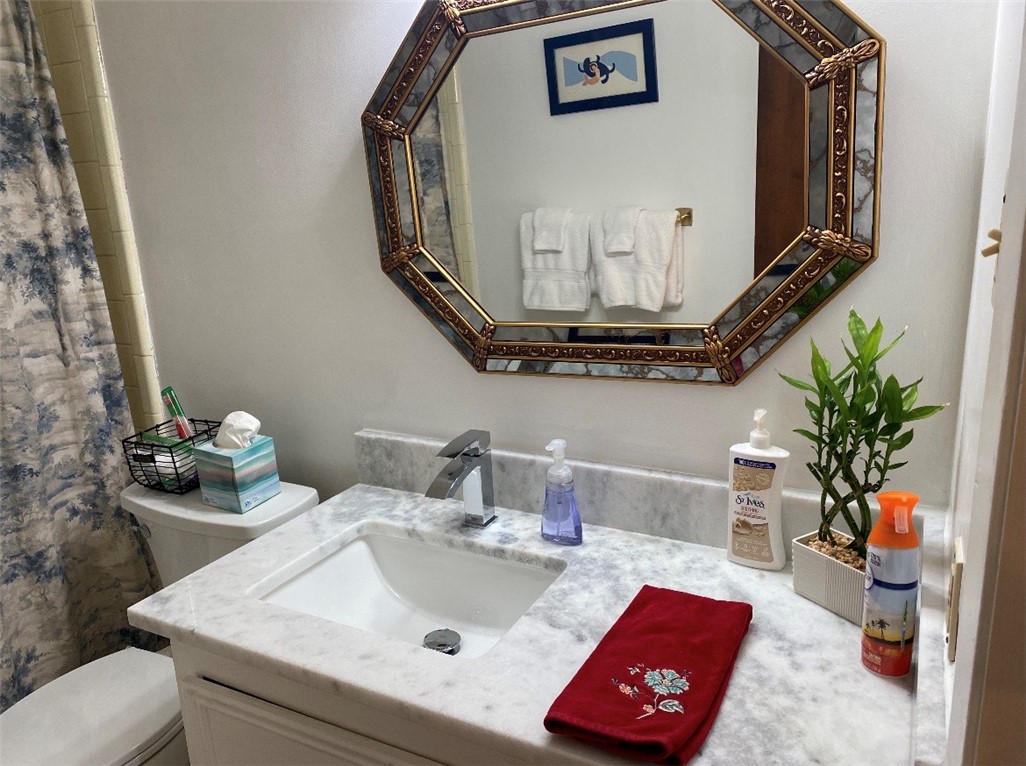 2902 Chaparral Circle Bryan, TX 77802 - Photo 19 of 26 a bathroom with a sink and a mirror