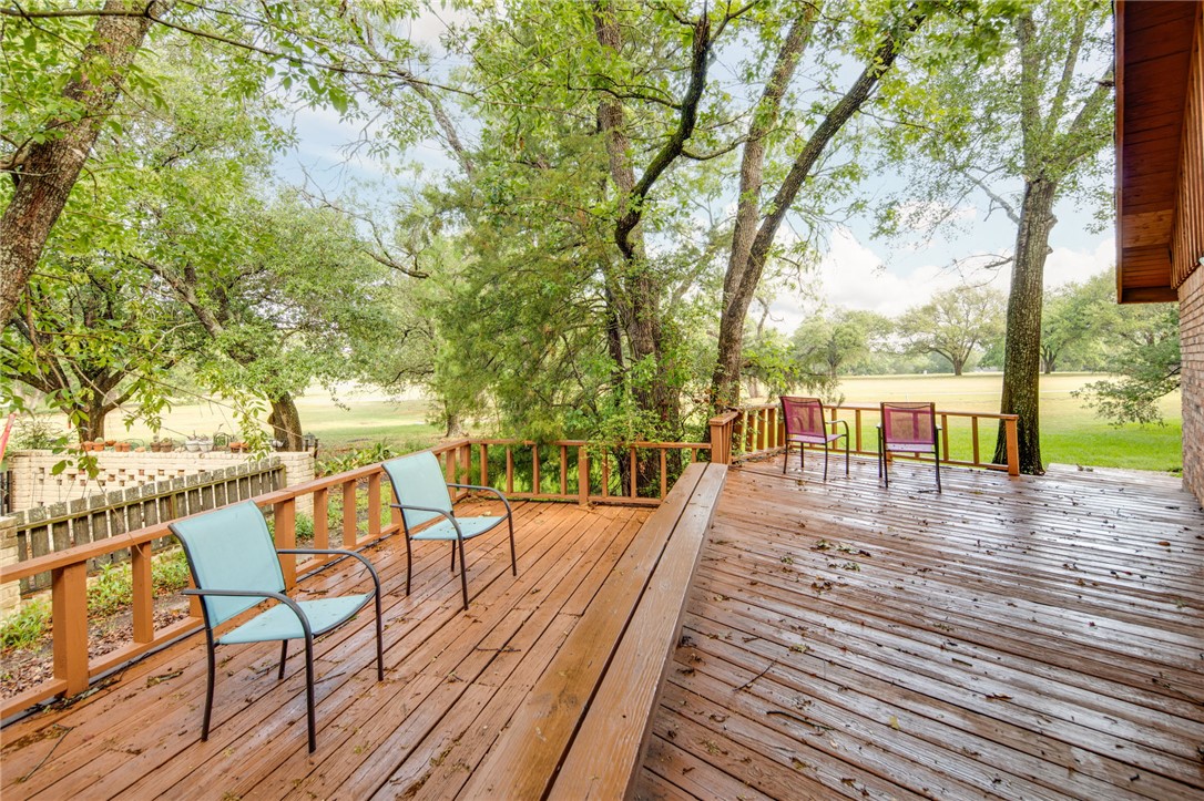 2902 Chaparral Circle Bryan, TX 77802 - Photo 23 of 26 a view of a patio with table and chairs with wooden floor and fence