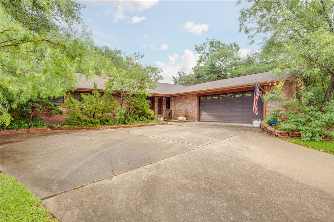 2902 Chaparral Circle Bryan, TX 77802 - Photo 3 of 26 a house with a yard