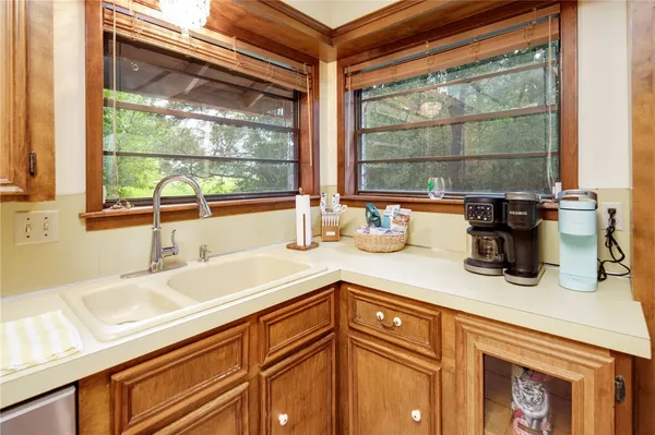 a kitchen with a sink and a large window