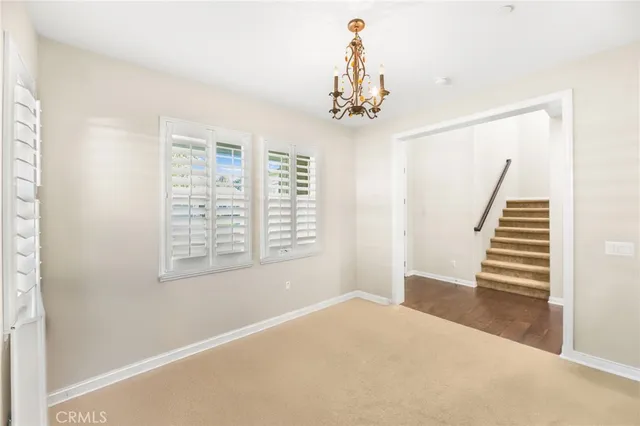 a living room with furniture a flat screen tv and a large window