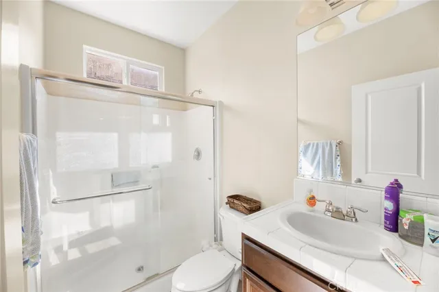 a bedroom with a large bed and a flat tv screen