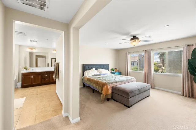 a spacious bathroom with a granite countertop sink mirror and a bathtub