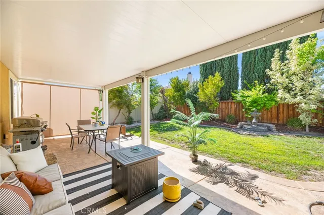 a view of a house with backyard porch and sitting area