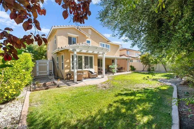 an aerial view of a residential houses with outdoor space and lake view