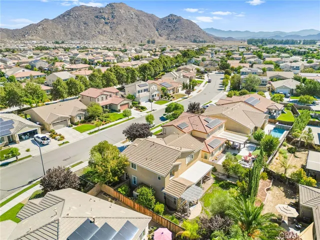an aerial view of a house a yard and outdoor seating