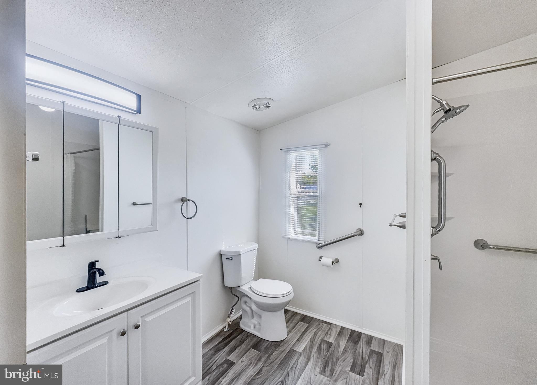 4820 Old Harrisburg Road Gettysburg, PA 17325 - Photo 7 of 15 a bathroom with a sink toilet a mirror and shower