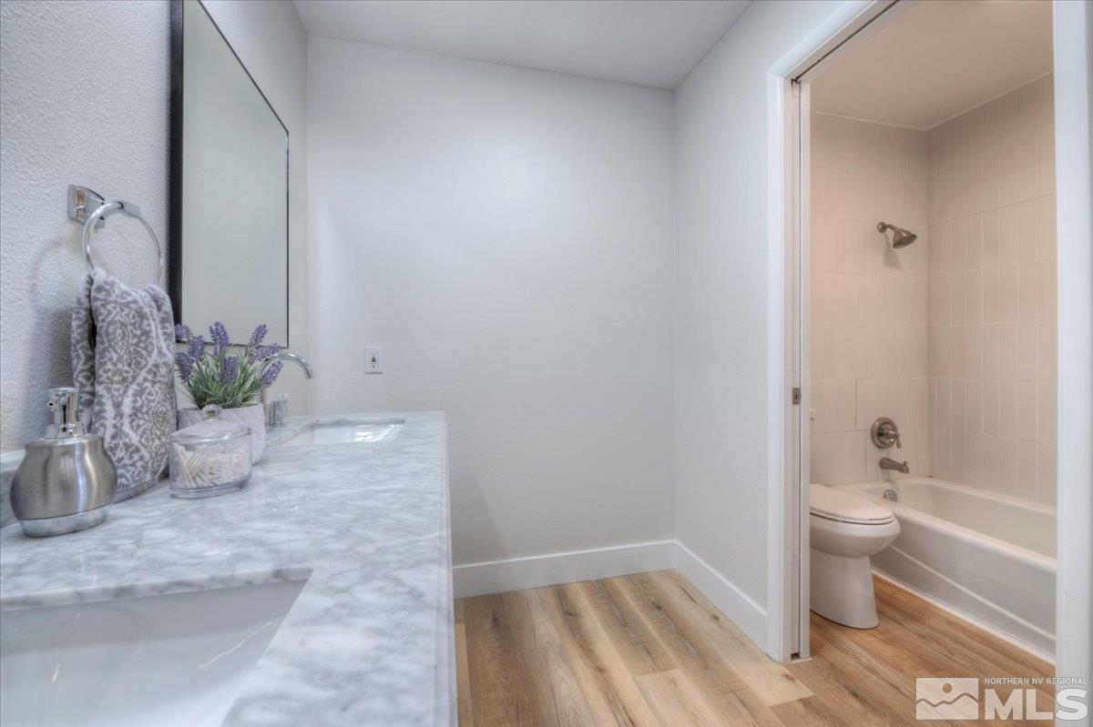 2014 Branch Reno, NV 89509 - Photo 17 of 40 a bathroom with a granite countertop sink a toilet and shower