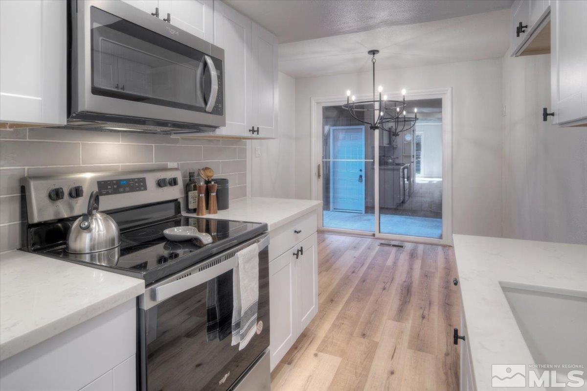 2014 Branch Reno, NV 89509 - Photo 2 of 40 a kitchen with stainless steel appliances granite countertop a stove and a microwave